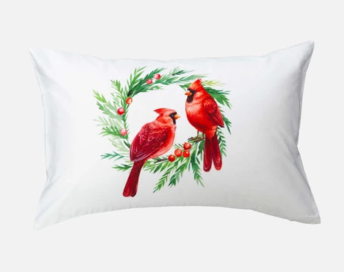 Front view of our first Cardinals Pillow Talk Pillowcase with two red cardinals landing on a holly wreath.