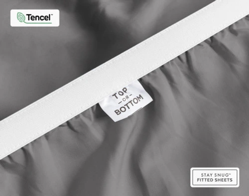 Close-up on the underside of our BeechBliss TENCEL™ Modal Fitted Sheet in Pewter Grey to show a tag stating "Top" and "Bottom".