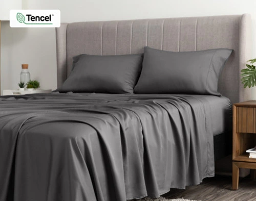 Angled view of a queen bed dressed in our BeechBliss TENCEL™ Modal Sheet Set in Pewter Grey.