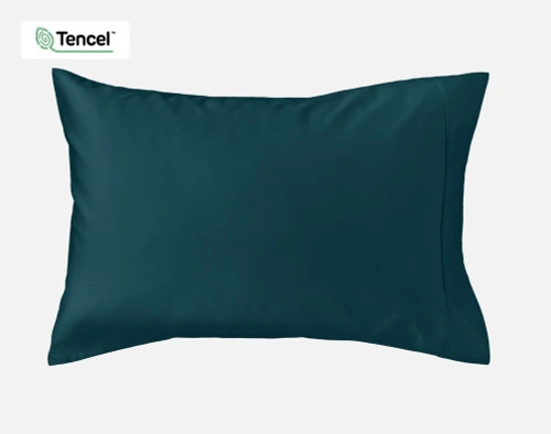 Front view of a Eucalyptus Luxe TENCEL™ Lyocell Pillowcase in Deep Ocean wrapped over a pillow sitting against a solid white background.