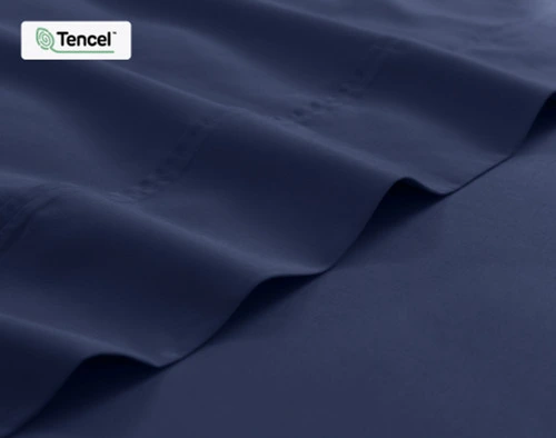 Close-up on the edge of the flat sheet for our Eucalyptus Luxe TENCEL™ Lyocell Sheet Set in Navy Blue.