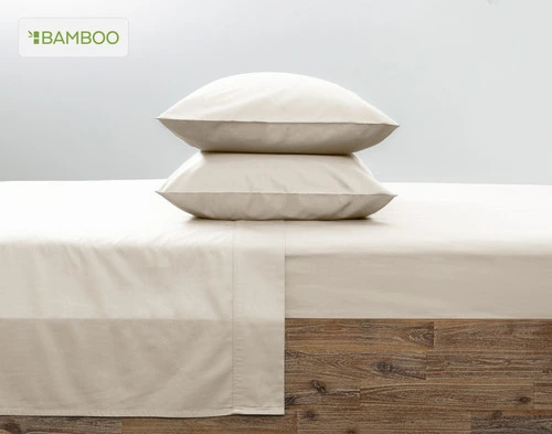 Two of our Bamboo Cotton Pillowcases in Driftwood Beige stacked on top of each other on a coordinating pink bed.