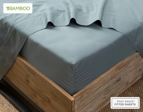 Flat sheet draped over our Bamboo Cotton Fitted Sheet in Spruce around the corner of a mattress.