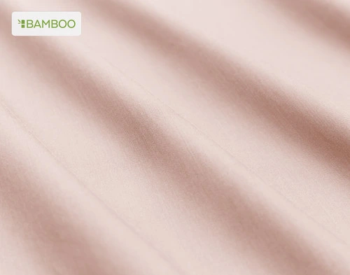 Close-up on the soft bamboo cotton fabric  on our Bamboo Cotton Sheet Set in Blush Pink slightly ruffled.