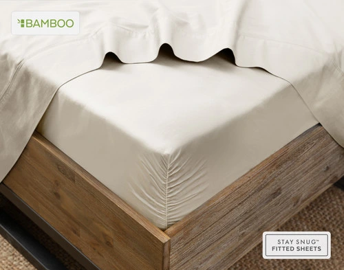 Flat sheet draped over our Bamboo Cotton Fitted Sheet in Driftwood Beige around the corner of a mattress.