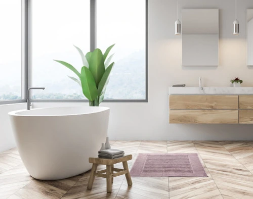 Modal Bath Mat in front of a modern white bathtub.