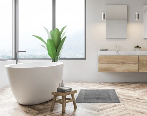 Modal Bath Mat in front of a modern white bathtub.