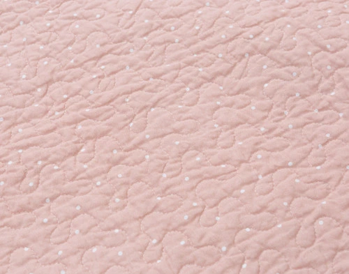 Close-up of the solid blush pink surface on our Annalise Quilt Set.