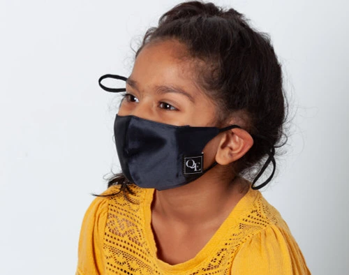 Picture shows a child wearing our Black silk face mask, side view.