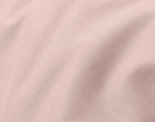 Close-up on the soft fabric over the surface of our Bamboo Cotton Duvet Cover in Blush, a light floral pink.