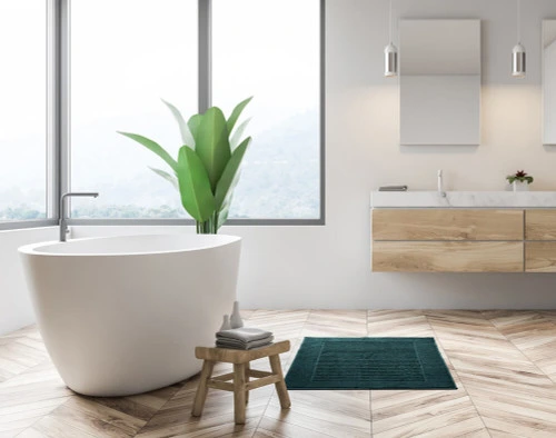 Modal Bath Mat in front of a modern white bathtub.