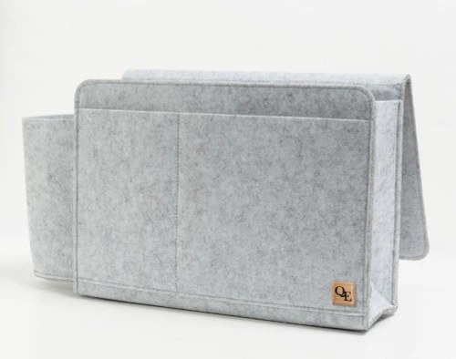 Angled view of our Bedside Felt Pocket in Light Grey sitting empty against a solid white background.