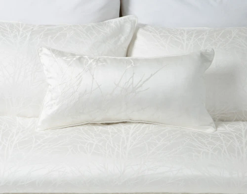 Our Blanchard White Boudoir Pillow Cover on white bedding.