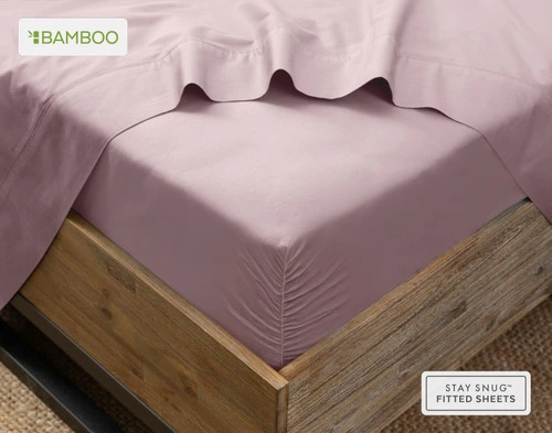 Flat sheet draped over our Bamboo Cotton Fitted Sheet in Orchid Purple around the corner of a mattress.