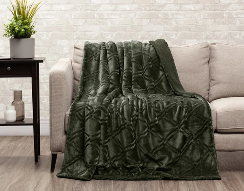 Front view of our Diamond Etched Throw in Rainforest draped over the seat of a couch.