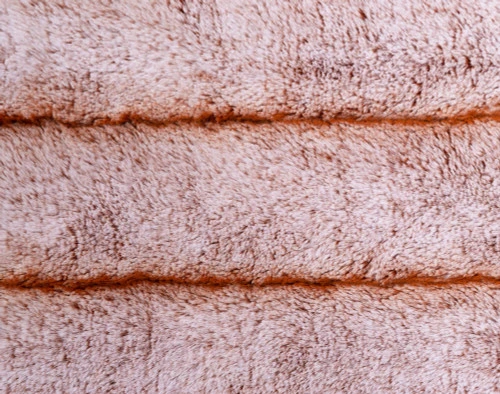 Front side of Tip-Dyed Faux Fur Throw Copper with ribbed fabric stripes and beige undertones.