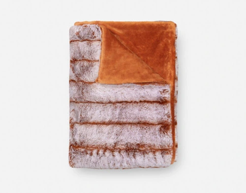 Tip-Dyed Faux Fur Throw in Copper folded into a small square.