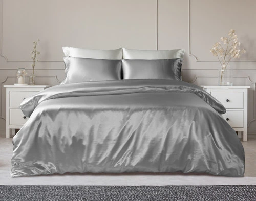 Our Silk Duvet Cover in Silver dressed over a classic bed in a white bedroom.