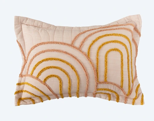 Our Maeve Pillow Sham with light flanged edge and circular orange tufting on a white background.