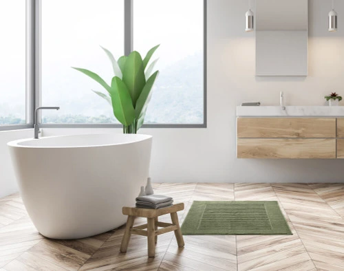 Our Modal Cotton Green Bath Mat in a tropical white & beige bathroom.