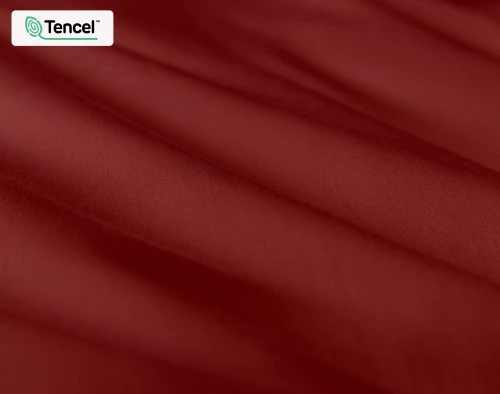 Close-up of our Eucalyptus Luxe TENCEL™ Lyocell Duvet Cover in Ruby to show its fabric lightly ruffled.