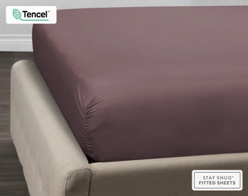 Corner of our BeechBliss TENCEL™ Modal Fitted Sheet in Inkberry Purple dressed over a mattress to show tight and comfortable fit.