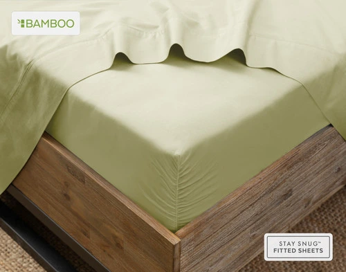 Flat sheet draped over our Bamboo Cotton Fitted Sheet in Elm Green around the corner of a mattress.