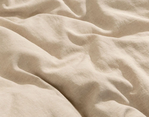 Close-up on the luxuriously soft and lightly heathered linen fabric on our Signature European Linen Duvet Cover in Natural.