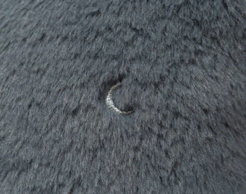 Close-up on small etched crescents on the surface of our QE Kids Blue Moon Plush Cushion.