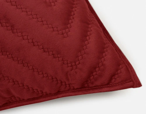 One closed corner of our Quilted Chevron Euro Sham in Red.