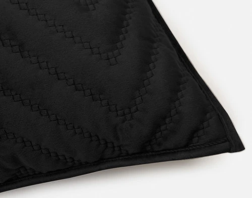 One closed corner of our Quilted Chevron Euro Sham in Black.