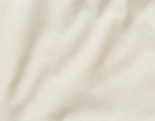 Close-up on the solid cotton backing on our Avalon Quilt Set in Champagne Gold.