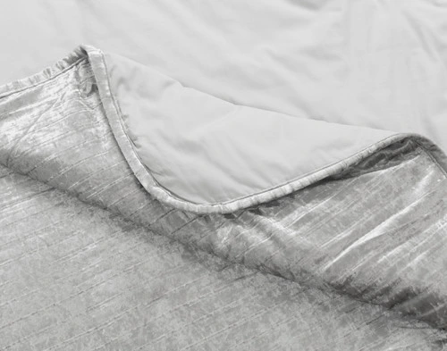 Folded corner on our Avalon Quilt Set in Silver to show its textural surface and solid cotton backing together.