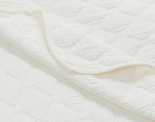 Folded corner on our Cavell White Cotton Quilt Set to show its soft folds.