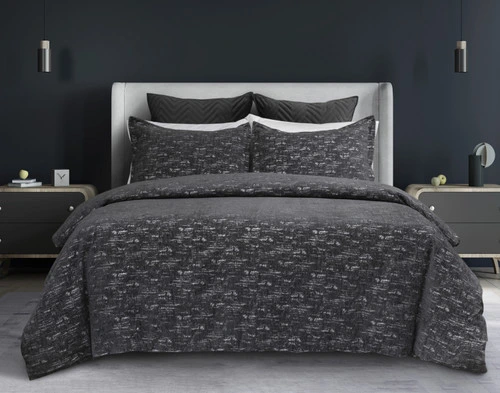 Our Flecks Duvet Cover Set dressed over a grey bed in a dark grey bedroom.