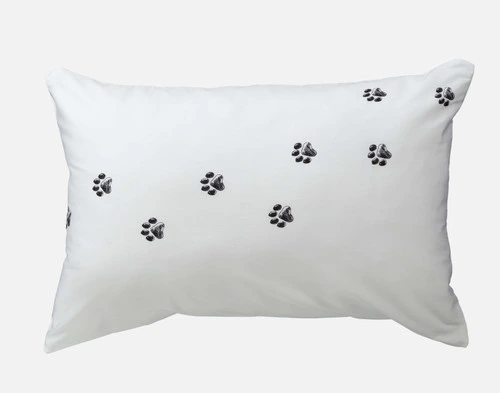 One of our Sleeping Cat Pillowcases featuring a design of paw prints walking across the surface.