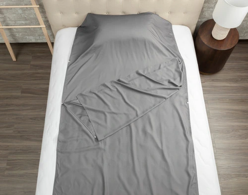 Top view of our TENCEL™ Modal Sleep Sack resting on a bed with the top layer half-open.