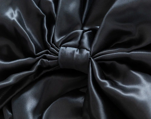 Close-up on the snug bow on our Mulberry Silk Hair Wrap in Black.