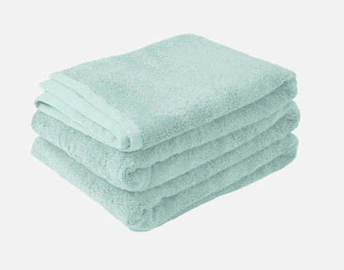 Our Modal Cotton Bath Sheets in Seafoam folded into a tidy pile.