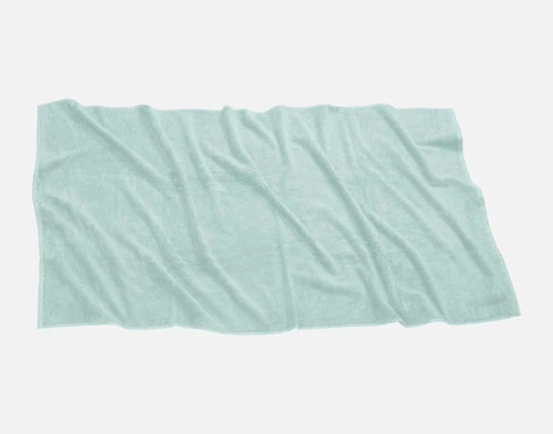 Top view of our Modal Cotton Bath Sheet in Seafoam laying ruffled over a solid ground.