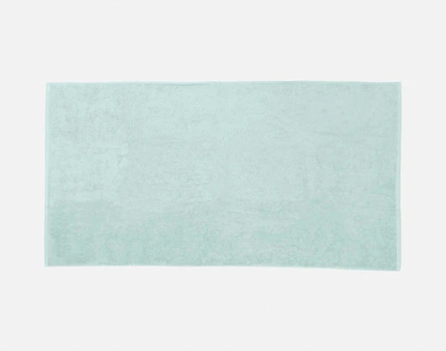 Top view of our Modal Cotton Bath Towels in Seafoam laying flat over a solid ground.