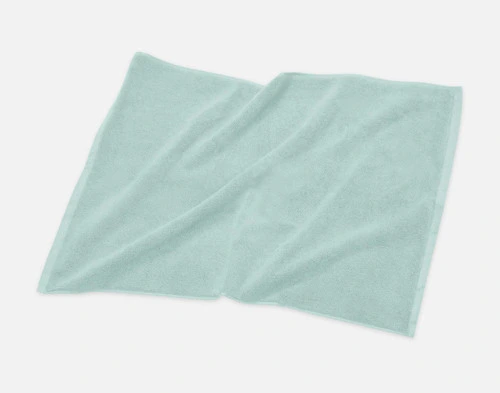 Angled view of our Modal Cotton Bath Mat in Seafoam sitting against a solid white background.