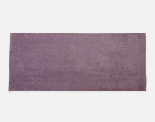 Top view of our Modal Cotton Bath Sheet in Lilac Ash laying flat over a solid ground.