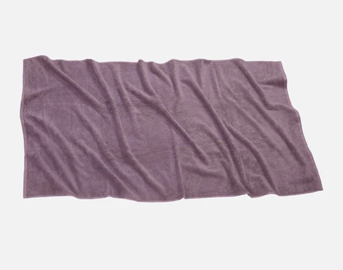 Top view of our Modal Cotton Bath Sheet in Lilac Ash laying ruffled over a solid ground.