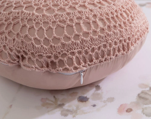 Close-up on the zipper enclosure and macramé texture on our Angelica Round Cushion.