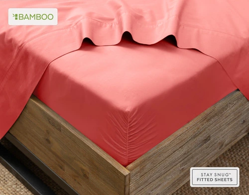 Flat sheet draped over our Bamboo Cotton Fitted Sheet in Hibiscus around the corner of a mattress.