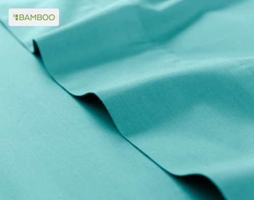 Flat sheet for our Bamboo Cotton Sheet Set in Reef Blue ruffled lightly over a matching smooth surface.