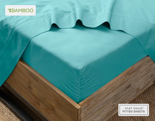 Flat sheet draped over our Bamboo Cotton Fitted Sheet in Reef Blue around the corner of a mattress.