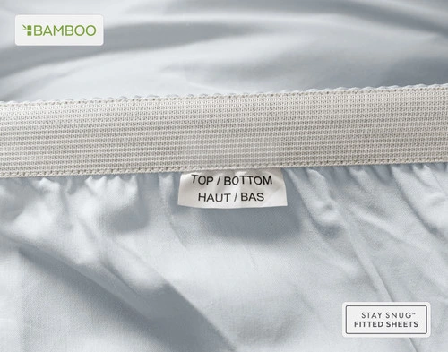 Edge of our Bamboo Cotton Fitted Sheet in Pearl Blue to show a tag stating "Top" and "Bottom."