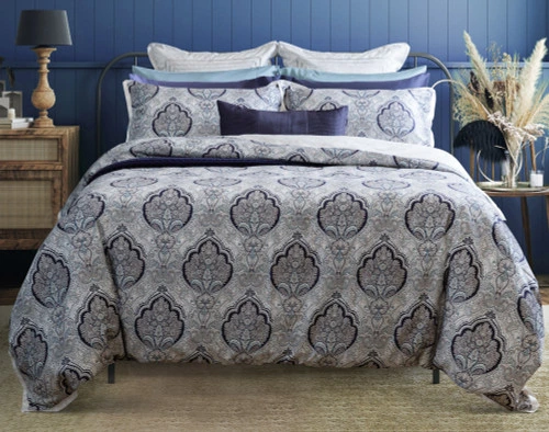 Our Dover Duvet Cover dressed over a queen bed with blue accessory pillowcases and cushions in a blue vacation bedroom.